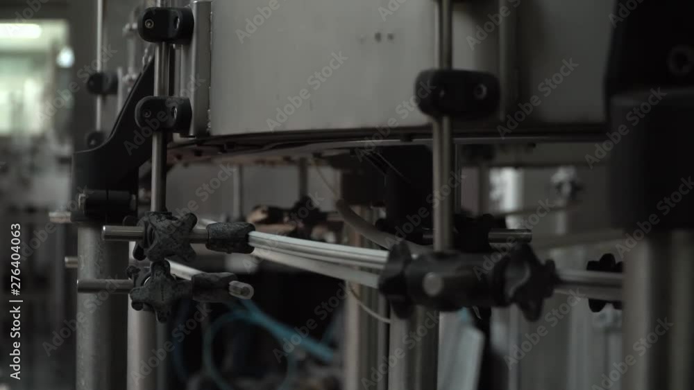 Production line of plastic bottles. Plastic bottles on automatic conveyor line. Plastic blanks go through the factory of plastic bottles. Production line of plastic bottles. Plastic bottles on automatic conveyor line. Plastic blanks go through the factory of plastic bottles.