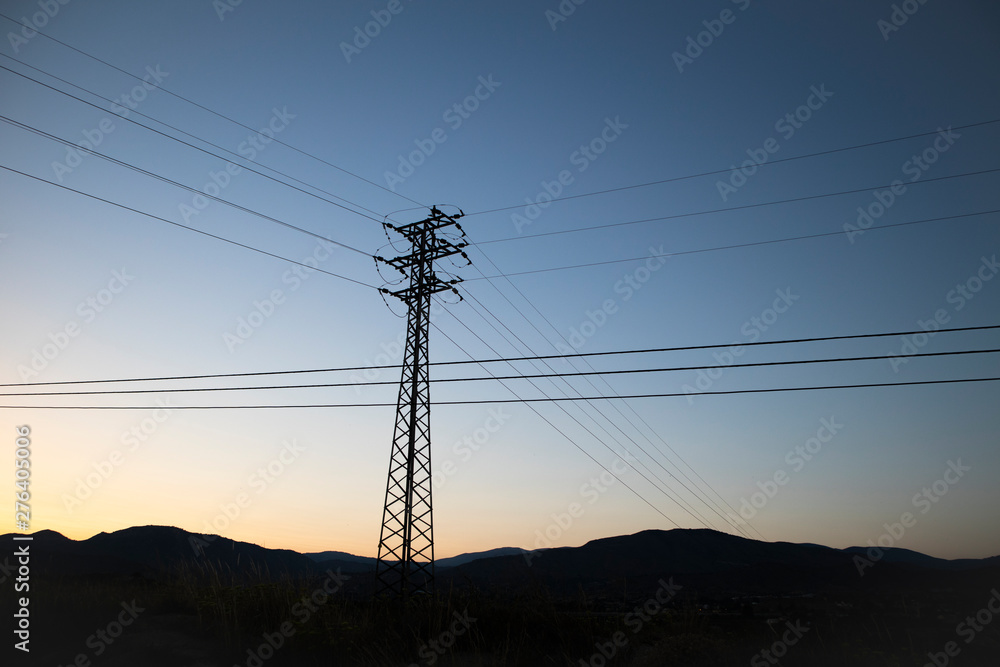 power lines and pylons at sunset