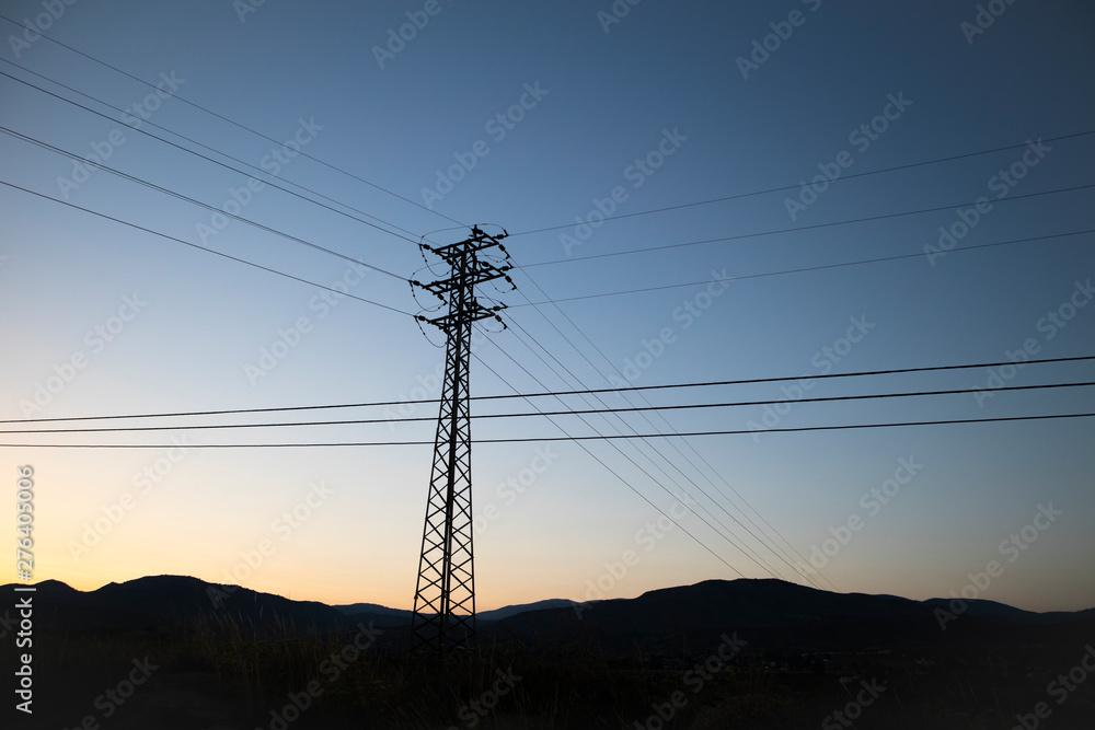 power lines and pylons at sunset power lines and pylons at sunset