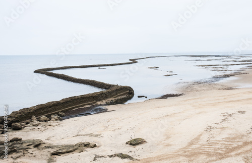 Ancient stone pens and algae to fish on the beaches of Chipiona