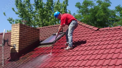 Wallpaper Mural House roof cleaning with water pressure tool. Worker on top of building washing tile with professional equipment. Moss removing. Torontodigital.ca