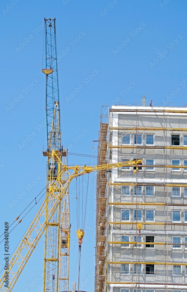 Building crane and building under construction Building crane and building under construction
