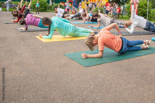 Children do exercises on the street. Children's fitness. Exercises for children to develop the body. Children's holiday. Zdorove baby activity. photo