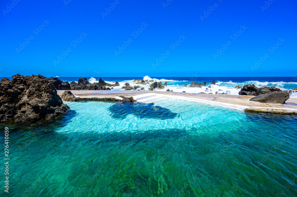 Natural volcanic swimming lagoon pools at Porto Moniz, travel destination for vacation, Madeira island, Portugal