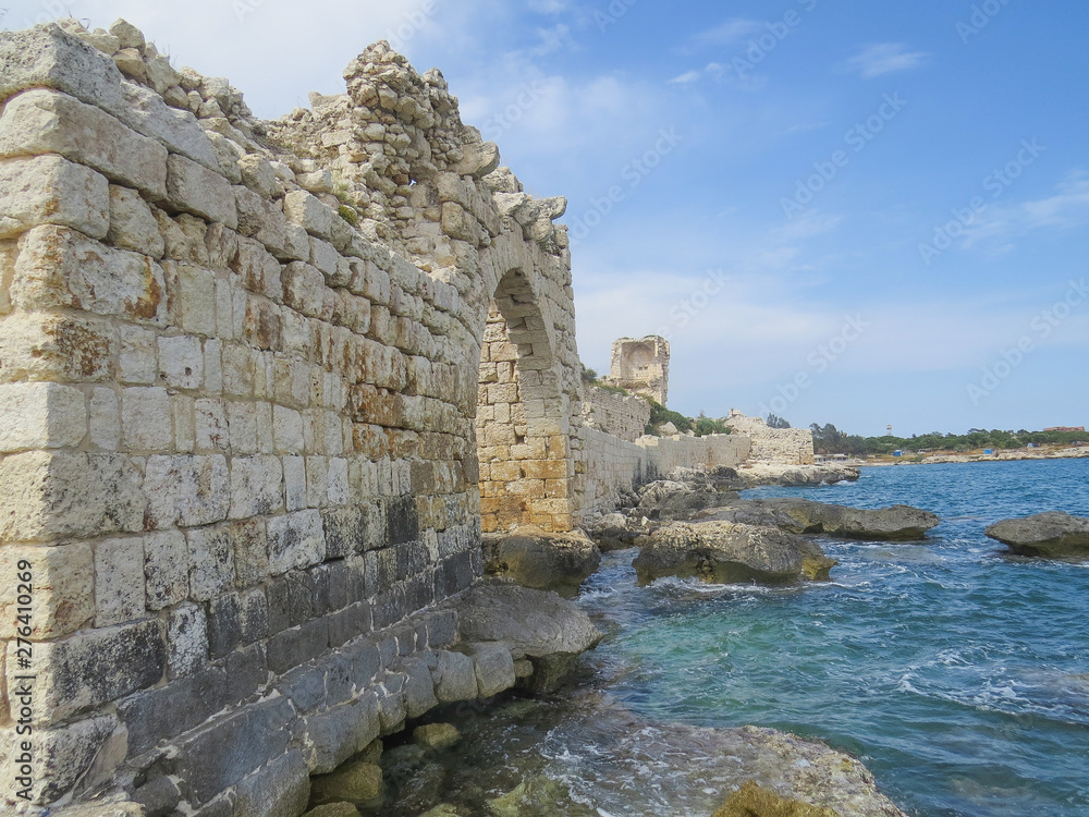 Mediterranean coastline. The picturesque ruins of the southern wall of the ancient city of Korikos.