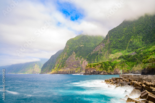 Beautiful wild coast scenery view with Bridal Veil Falls (Veu da noiva) at Ponta do Poiso in Madeira Island. Near Porto Moniz, View from Seixal, Portugal. photo