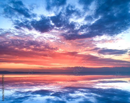 Amazing sunset and sky reflection in the water. © Denis Rozhnovsky