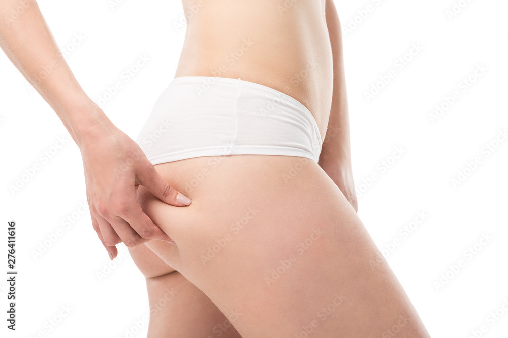 cropped view of young slim woman in panties touching buttocks isolated on white