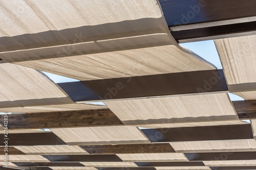 Große Terrassenüberdachung mit Stoffbahnen und Holzbalken als Sonnenschutz  Stock Photo | Adobe Stock