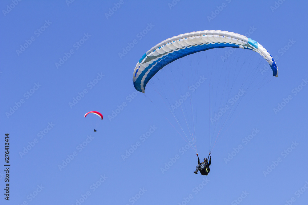 Paragliding in the blue sky as background extreme sport Paragliding in the blue sky as background extreme sport