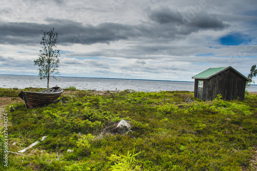 Desserted boat in sea coastline in an island with beautiful landscape and panoromic view with horizon and cloud photo