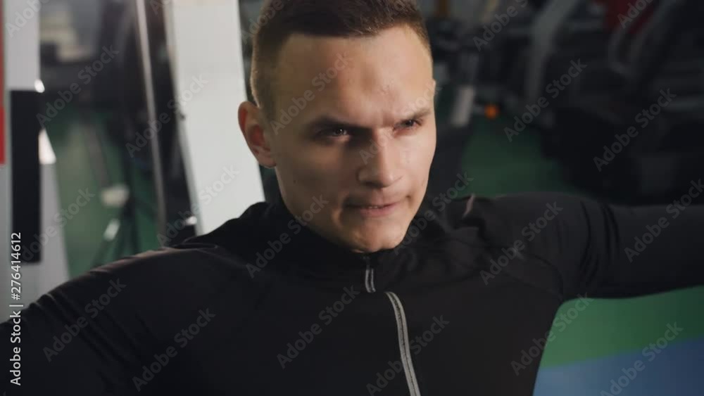 Concentrated man doing exercises in the gym. A man training in the gym after work. Concentrated man doing exercises in the gym. A man training in the gym after work.