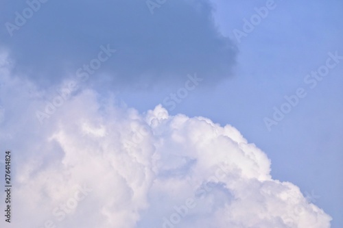White dark fluffy clouds against blue sky for background texture © Oradige59