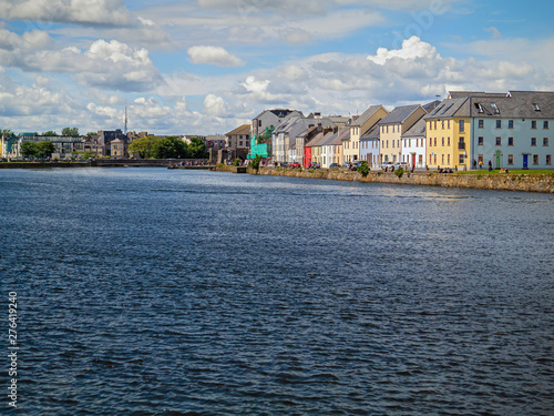 Corrib river, Galway city, High tide, The long walk, Sunny day, cloudy sky. Blue water. Colorful houses.