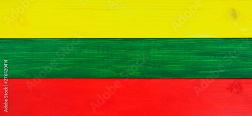 Lithuania flag in panorama / wide banner tricolors - in natural, wooden texture - background design for Lithuanian culture.