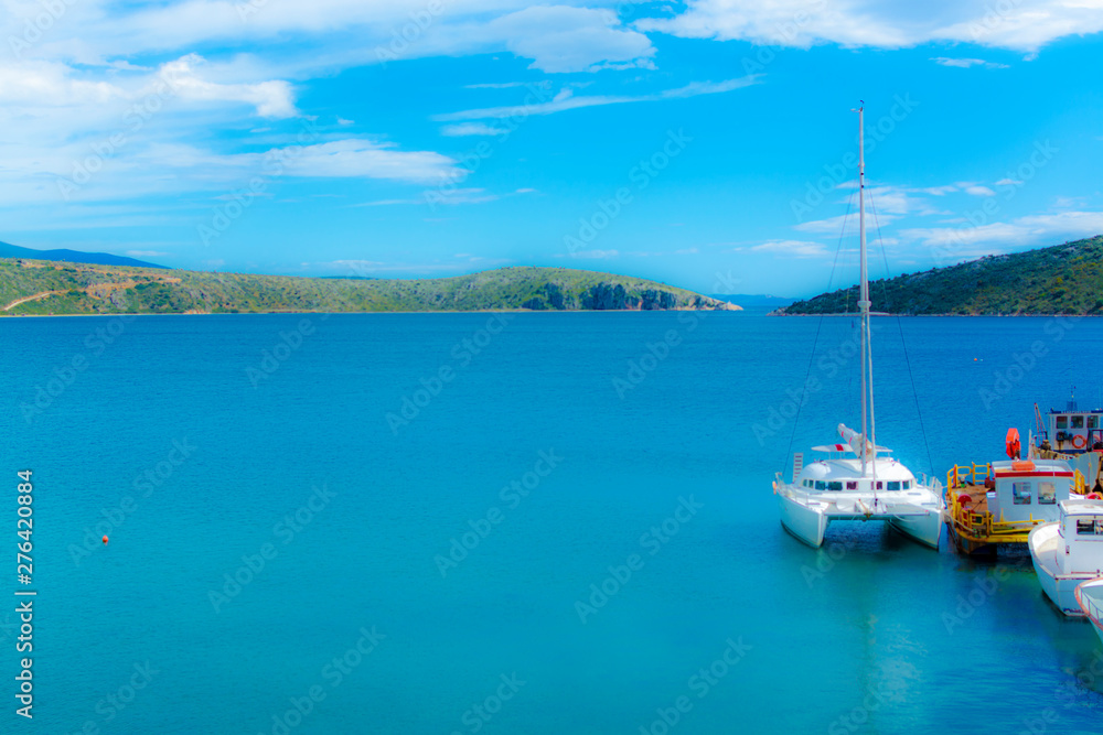 Blurred seascape with big white catamaran yacht boat, vacation destination