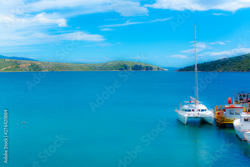 Blurred seascape with big white catamaran yacht boat, vacation destination
