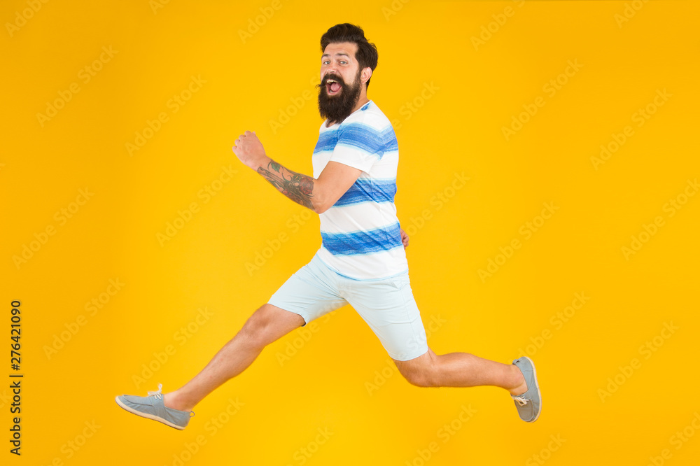 Hurry up. Summer vacation. Man bearded hipster with mustache long beard running yellow background. Guy dressed striped shirt on summer vacation. Barbershop concept. Summer style. Sale and discount - obrazy, fototapety, plakaty 