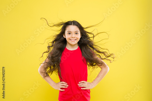 Perfect curls. Kid cute face with adorable curly hairstyle. Little girl grow long hair. Teen fashion model. Discover difference. Styling curly hair. Hairdresser tip. Kid girl long healthy shiny hair