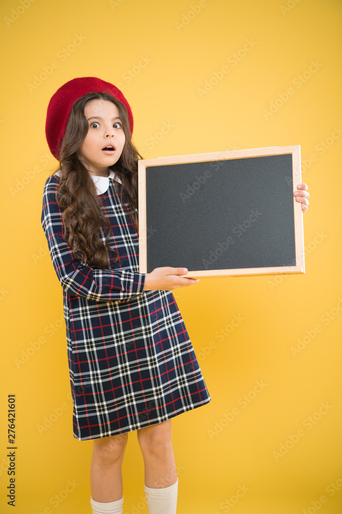 expressing surprise, school shopping sales. child on yellow background. advertising board for promotion. happy girl in french beret. back to school. small girl kid with school backboard, copy space expressing surprise, school shopping sales. child on yellow background. advertising board for promotion. happy girl in french beret. back to school. small girl kid with school backboard, copy space