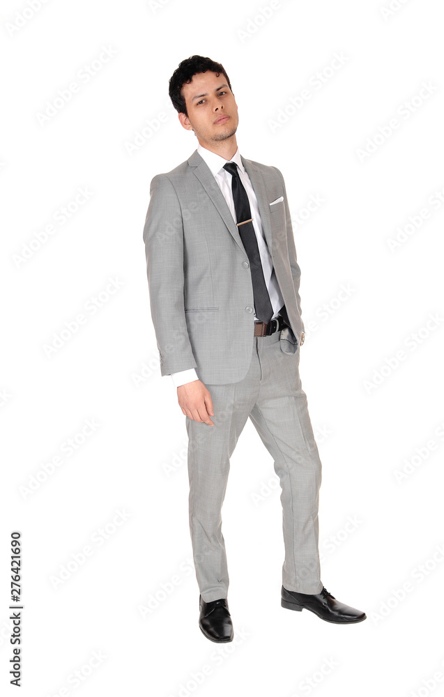 Young business man standing relaxed in a gray suit Young business man standing relaxed in a gray suit