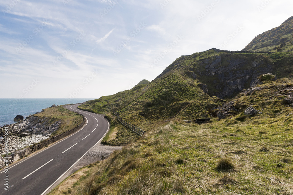 Road by the sea on Causeway coastal route in county antrim, Northern Ireland Road by the sea on Causeway coastal route in county antrim, Northern Ireland
