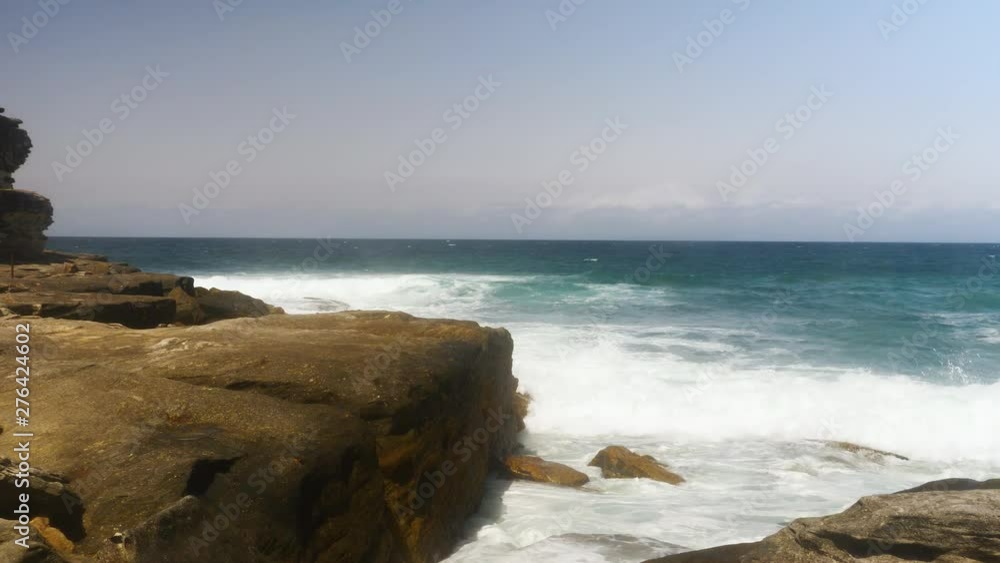Ocean waves move into the shore on a hot summers day. SLOW MOTION Ocean waves move into the shore on a hot summers day. SLOW MOTION