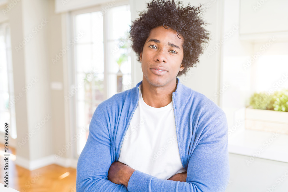 African American man at home Relaxed with serious expression on face. Simple and natural with crossed arms African American man at home Relaxed with serious expression on face. Simple and natural with crossed arms