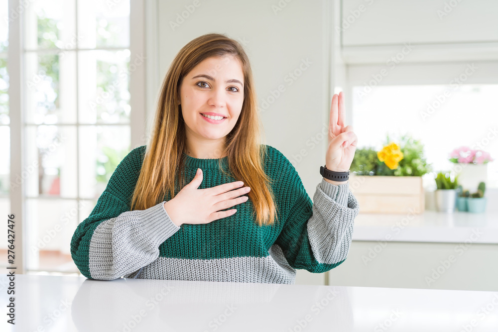 Young beautiful plus size woman wearing casual striped sweater smiling swearing with hand on chest and fingers up, making a loyalty promise oath Young beautiful plus size woman wearing casual striped sweater smiling swearing with hand on chest and fingers up, making a loyalty promise oath