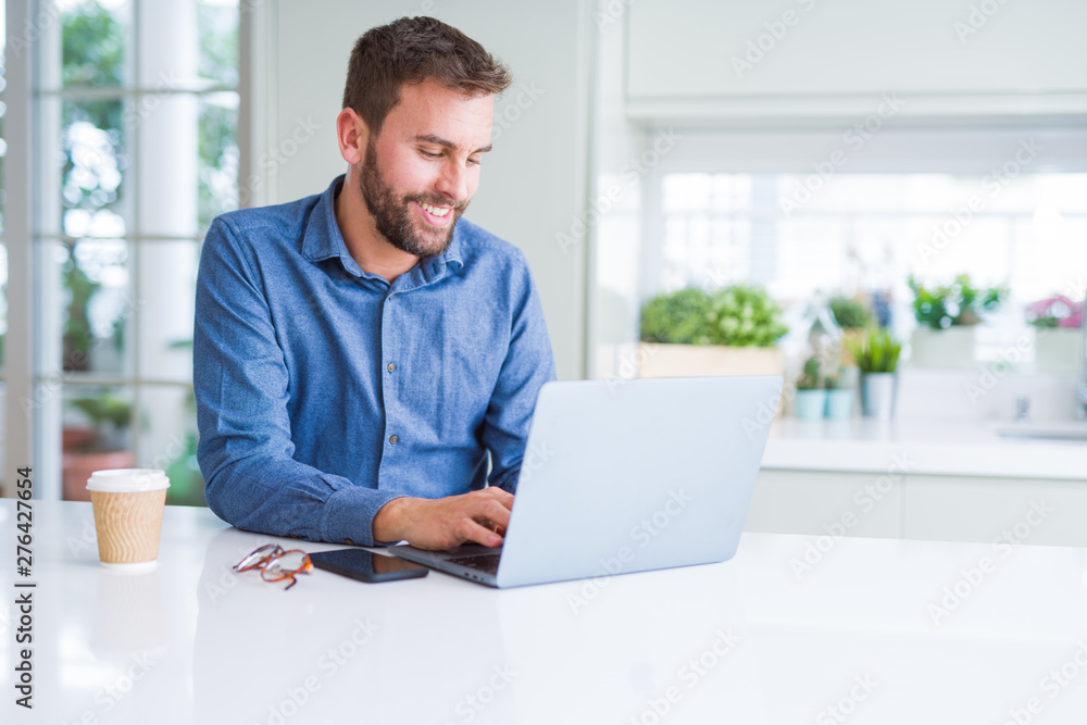 Handsome business man working using computer laptop and smiling Handsome business man working using computer laptop and smiling