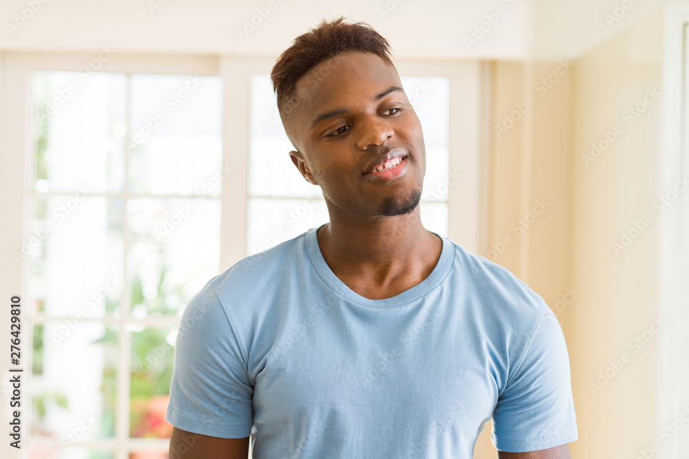 Handsome african young man smiling cheerful with a big smile on face Handsome african young man smiling cheerful with a big smile on face