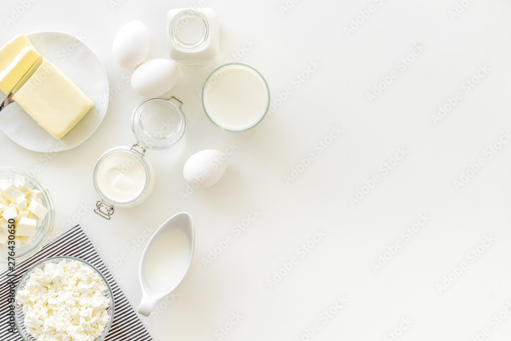Fototapeta premium Dairy products from farm with milk, eggs, cottage, butter, yougurt on white background top view mockup