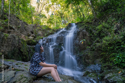 Women love to travel and hiking Adventure photographed young Thai people in Asia. Take yourself while walking on the   Ton Sai Waterfall   in the forest tropical zone national park Phuket Thailand.