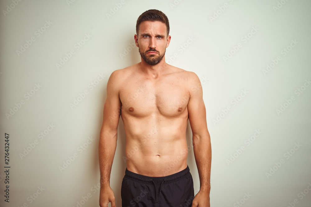 Fototapeta premium Young handsome shirtless man over isolated background depressed and worry for distress, crying angry and afraid. Sad expression.