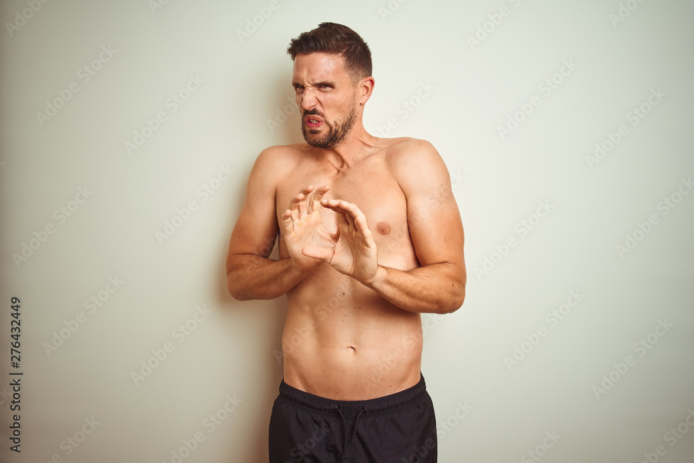 Young handsome shirtless man over isolated background disgusted expression, displeased and fearful doing disgust face because aversion reaction. With hands raised. Annoying concept. Young handsome shirtless man over isolated background disgusted expression, displeased and fearful doing disgust face because aversion reaction. With hands raised. Annoying concept.