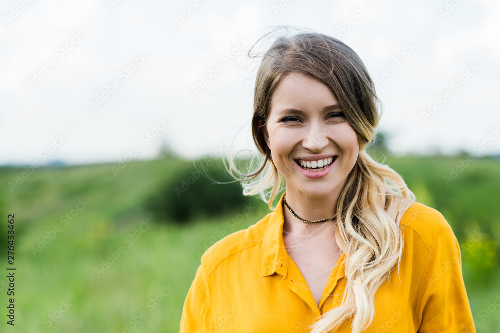 positive young woman smiling while looking at camera positive young woman smiling while looking at camera