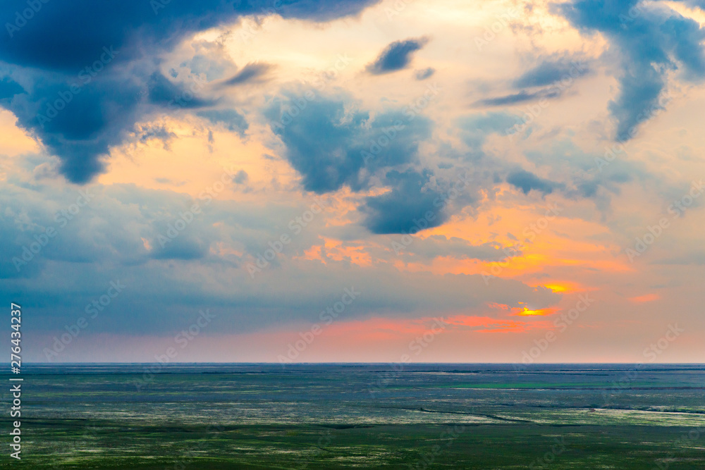 Scenic sunset with clouds in sky in steppe