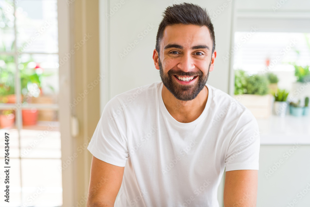 Handsome man smiling cheerful with a big smile on face showing teeth, positive and happy expression Handsome man smiling cheerful with a big smile on face showing teeth, positive and happy expression
