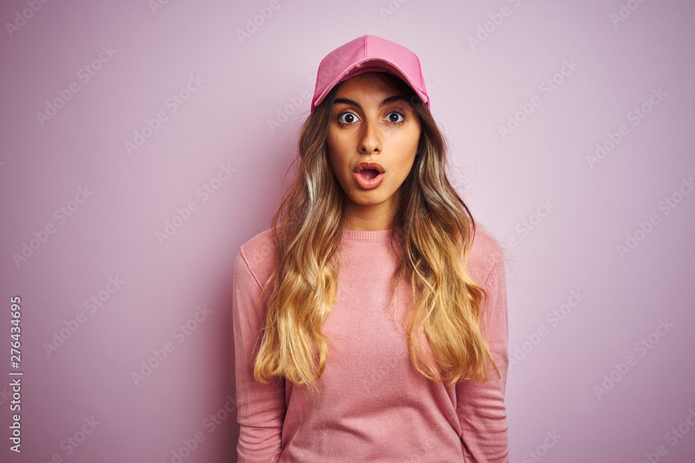 Young beautiful woman wearing cap over pink isolated background afraid and shocked with surprise expression, fear and excited face. Young beautiful woman wearing cap over pink isolated background afraid and shocked with surprise expression, fear and excited face.