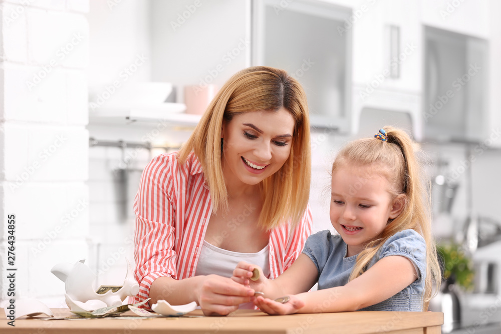 Family with broken piggy bank and money at home Family with broken piggy bank and money at home