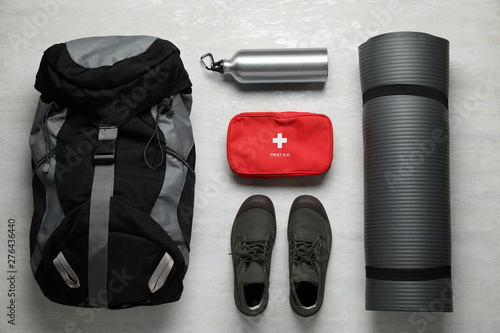 Flat lay composition with different camping equipment on light background