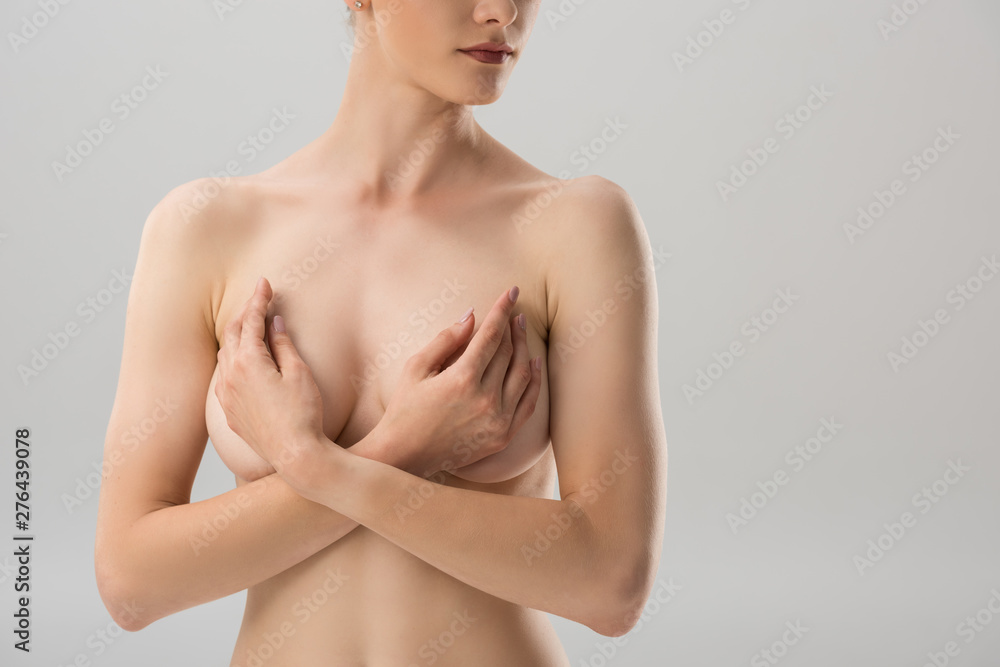 partial view of sexy naked girl covering breast isolated on grey partial view of sexy naked girl covering breast isolated on grey