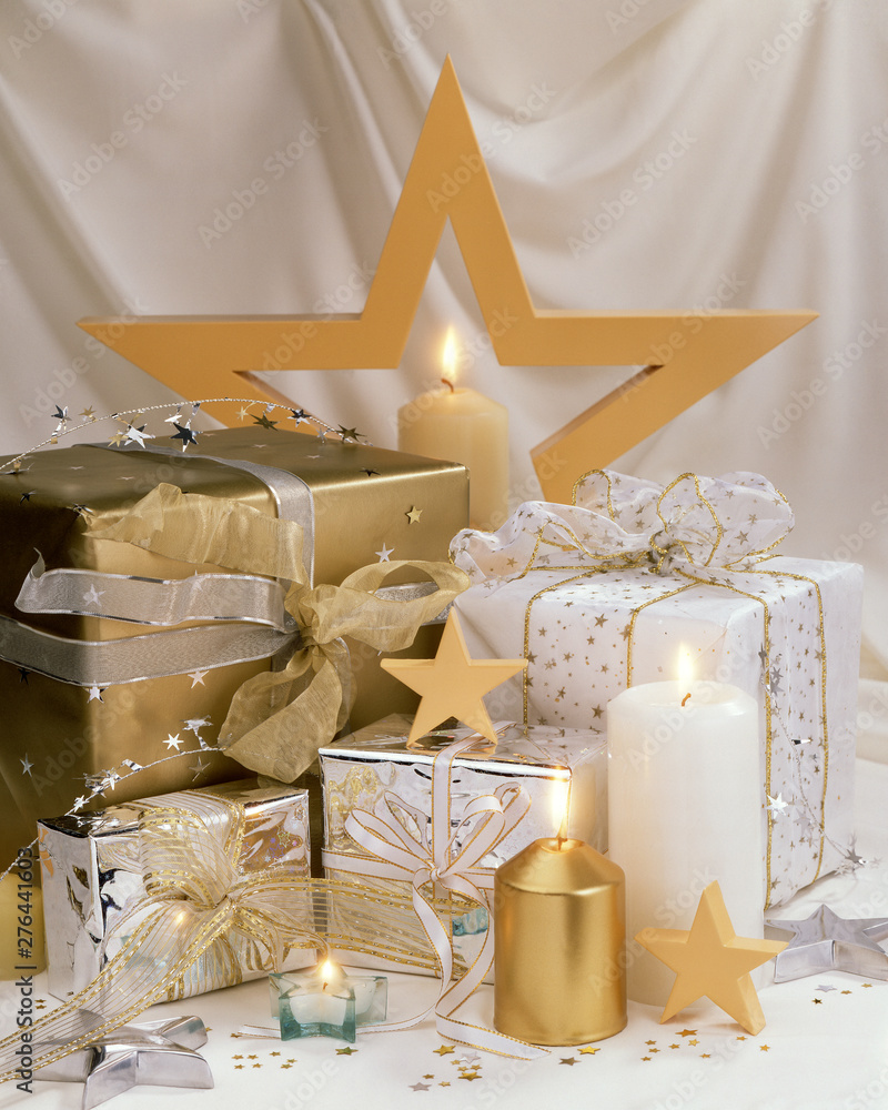 A layout of holiday gifts with candles and stars - obrazy, fototapety, plakaty 