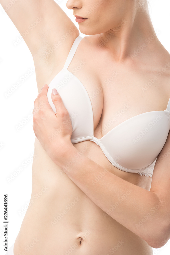 partial view of young woman in bra doing breast self-examination isolated on white