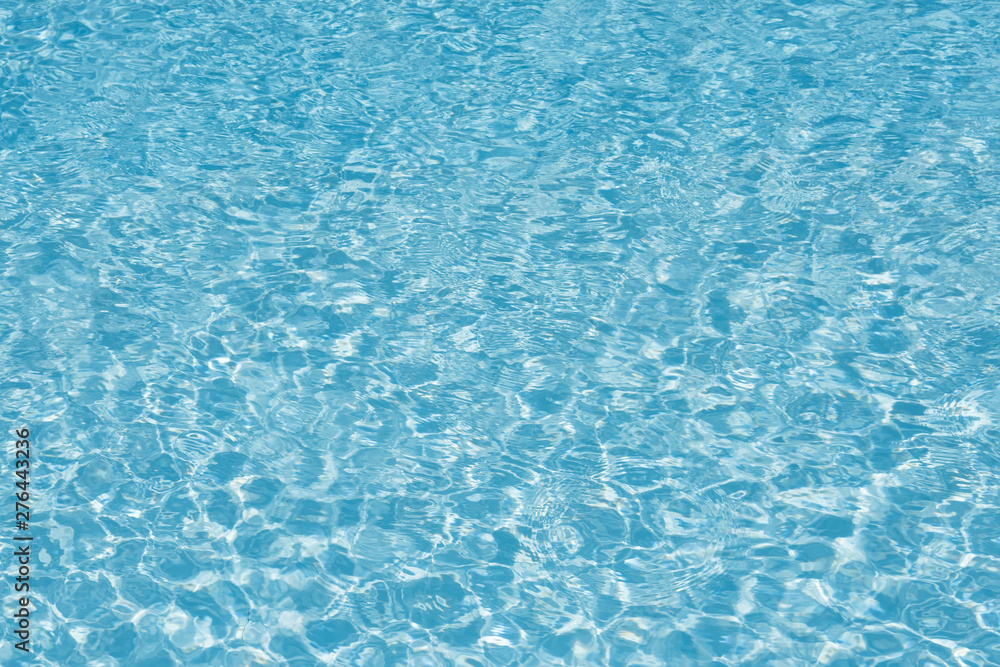 Blue water in pool for background and abstract, Ripple wave with sun reflection in swimming pool