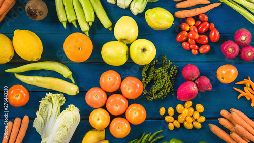 Flat lay of fresh  fruits and vegetables for background, Different fruits and vegetables for eating healthy, Colorful fruits and vegetables on blue plank background photo