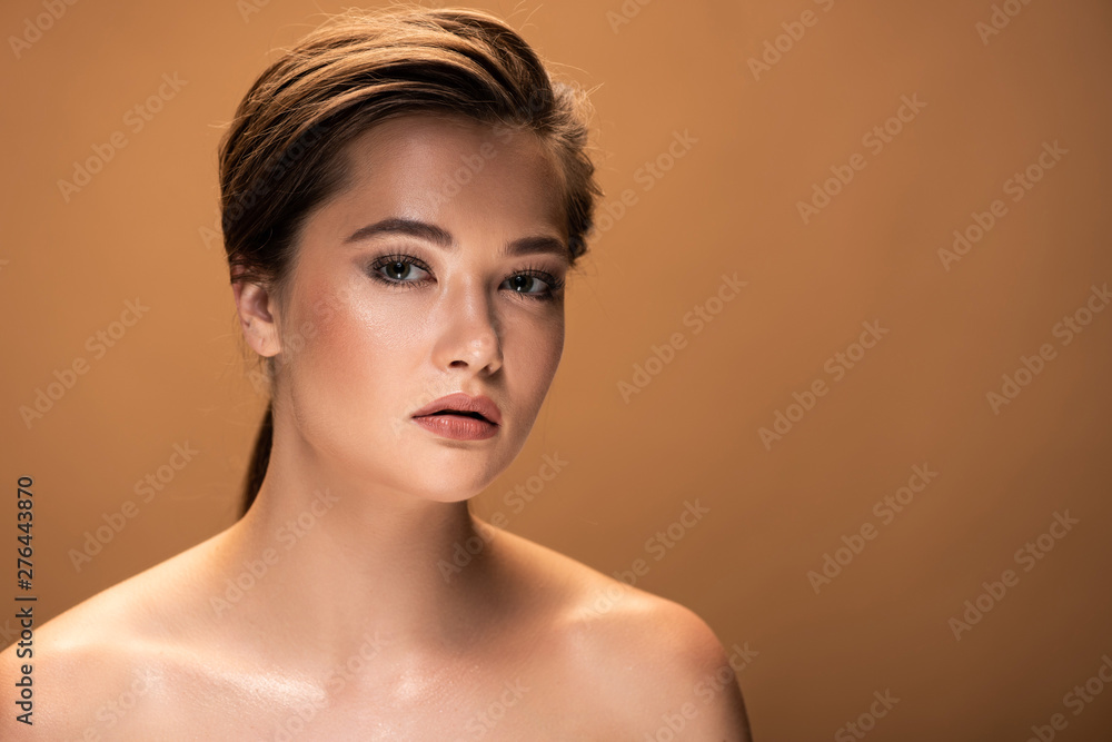 young beautiful naked woman with shiny makeup looking at camera isolated on beige young beautiful naked woman with shiny makeup looking at camera isolated on beige