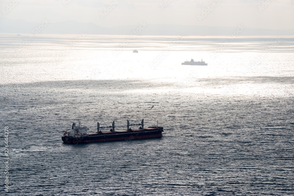 A large cargo ship passing through the straight of Gibraltar A large cargo ship passing through the straight of Gibraltar