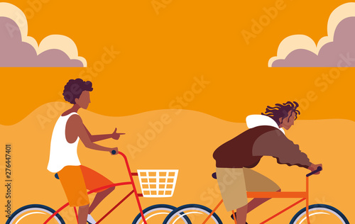 young men african riding bike with sky orange
