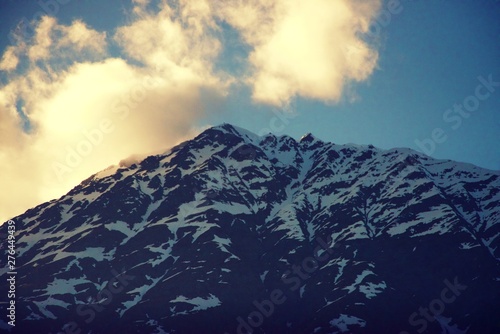Sunlight highlighting the snowy mountain peaks in Alaska 